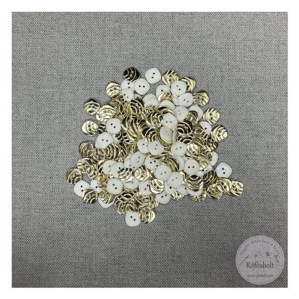 Hátán fehér, színén csillogó arany, csíkos, két lyukú